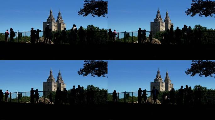 白天夏天在中央公园建立剪影游客的照片