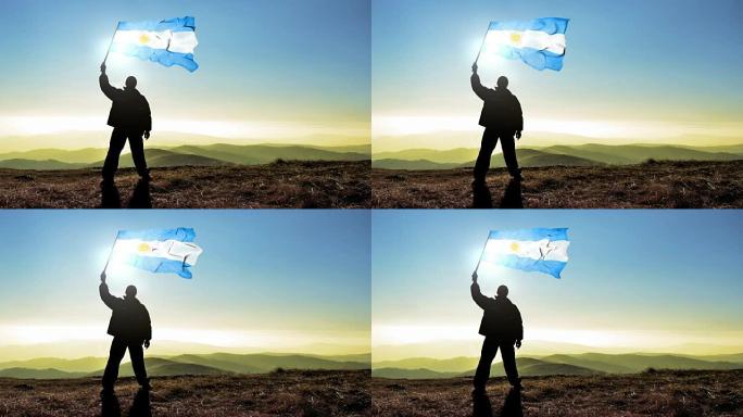 成功的剪影男子获胜者在山顶上挥舞着阿根廷国旗，4k电影院