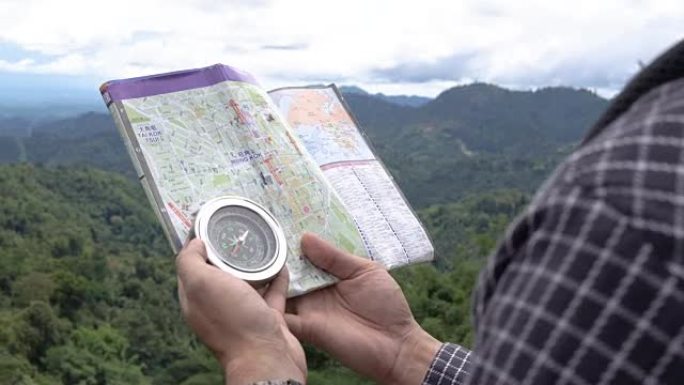 亚洲男子游客看指南针和地图，泰国