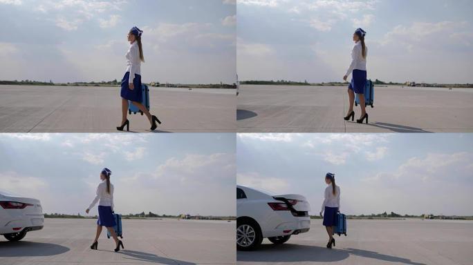 穿着高跟鞋和制服的空姐带着手提箱沿着机场奔跑