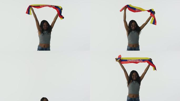 快乐的非裔美国人球迷高举哥伦比亚国旗庆祝
