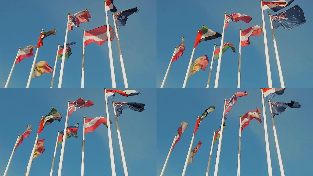 许多不同国家的旗帜，旗帜随风飘动。慢动作