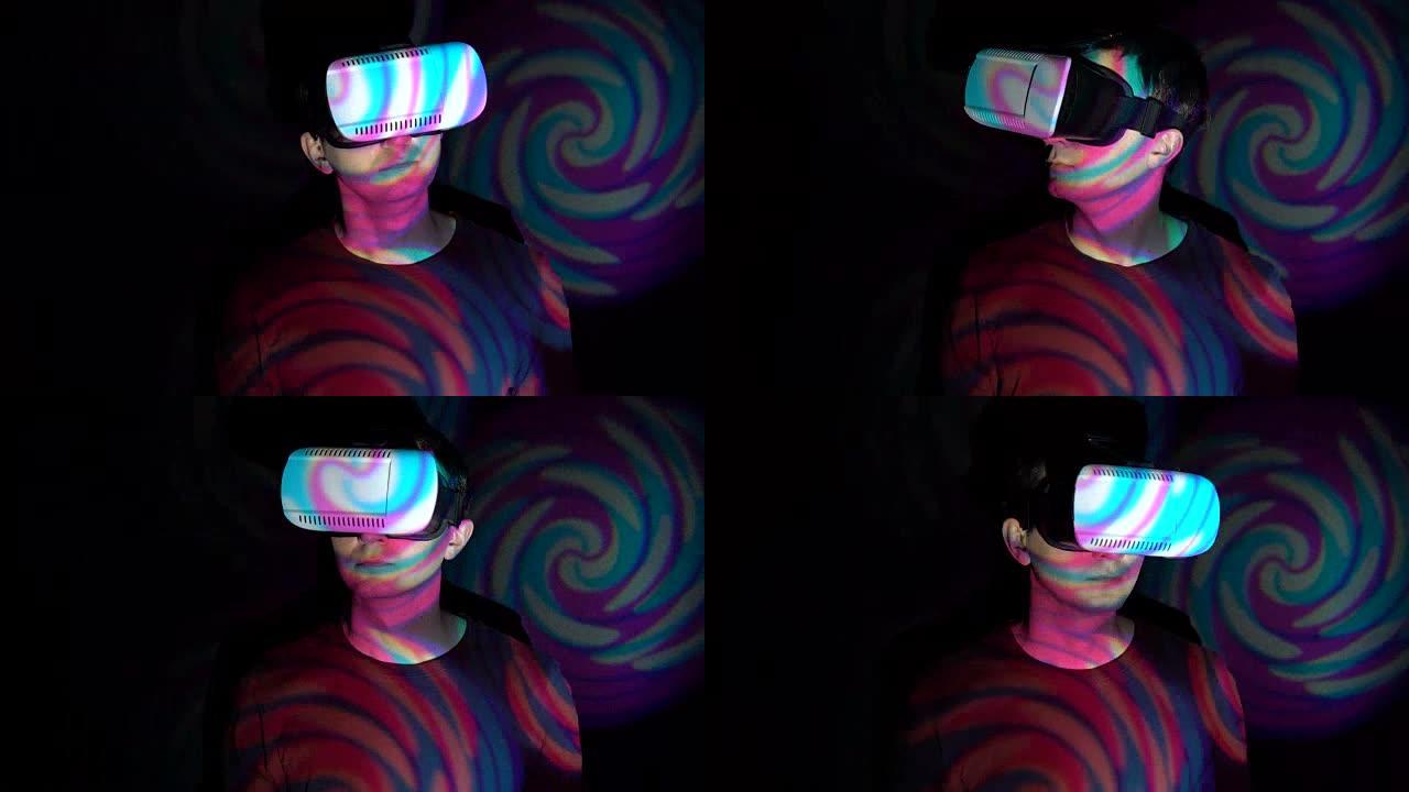 在聚光灯下使用VR眼镜的人