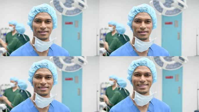 穿着磨砂膏的男性外科医生在镜头前微笑