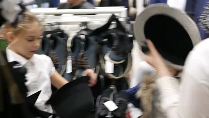 商店里的三个女孩正在看帽子。