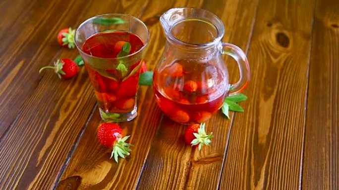 玻璃倾水器中的成熟红色草莓的甜蜜饯