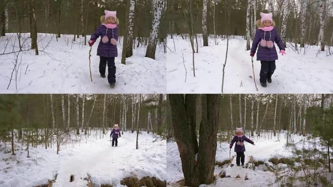 小女孩在冬季森林里沿着小路奔跑。女孩克服障碍。手拿棍子的女孩站起来走路。