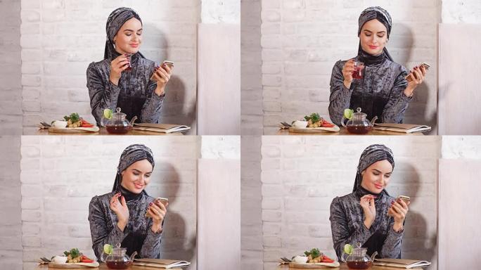 使用手机的快乐穆斯林妇女肖像
