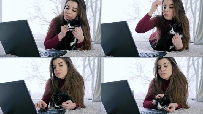 居家舒适，有猫的好女孩使用笔记本电脑在互联网上进行交流