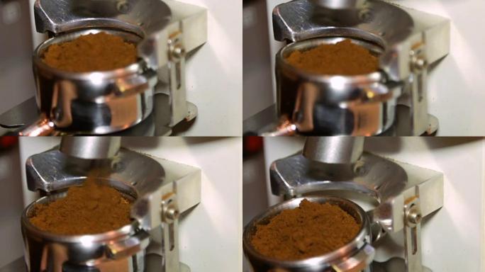 咖啡师研磨和分配研磨咖啡从研磨机到portafilter。