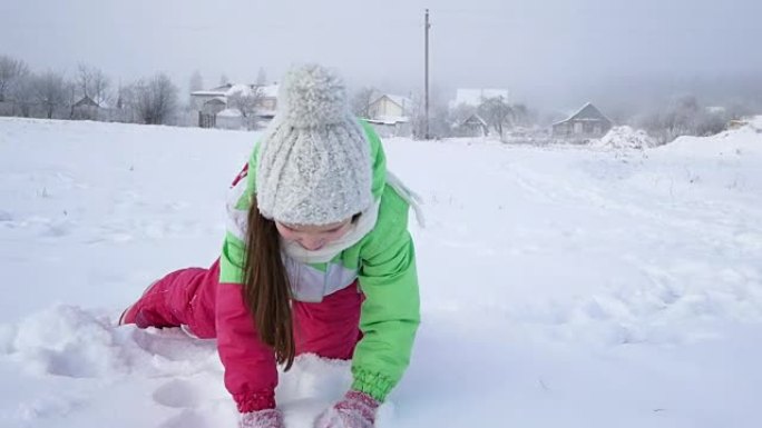 Girl has fun in the winter, throwing a handful of 