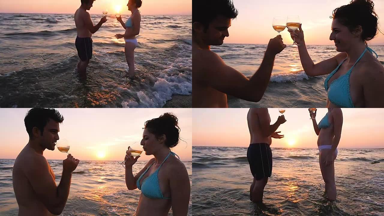 夏日之恋: 年轻夫妇在海上日落时敬酒