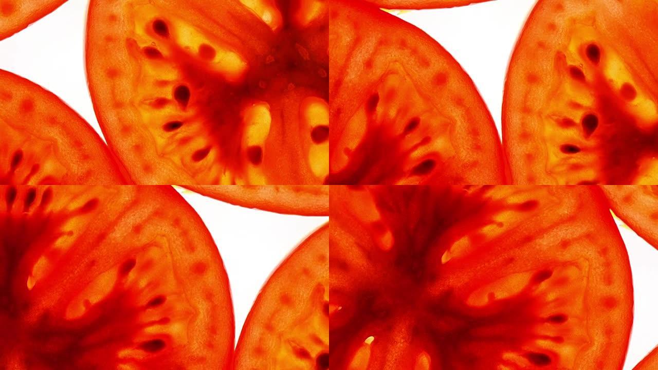 切成薄片的新鲜红番茄的绝佳俯视图，喜欢苹果，平躺特写，顺时针旋转，中心向下。