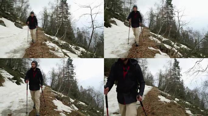 背包男徒步行走在雪道上。在前面。真正的背包客成人徒步旅行或徒步旅行在秋冬野外野外的山区自然，大雾天气