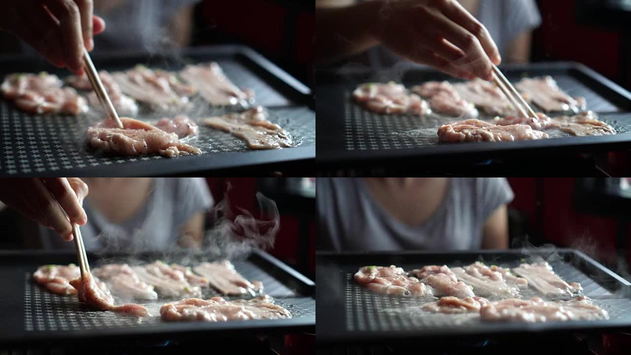 韩国，日本烧烤手用筷子在热锅上带肉视频