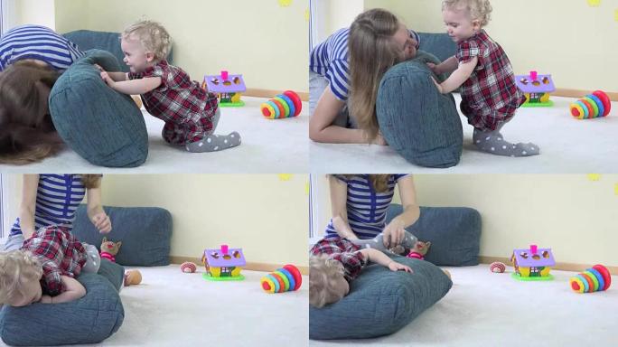 妈妈和蹒跚学步的孩子玩蓝色大枕头，表现出真实的情感