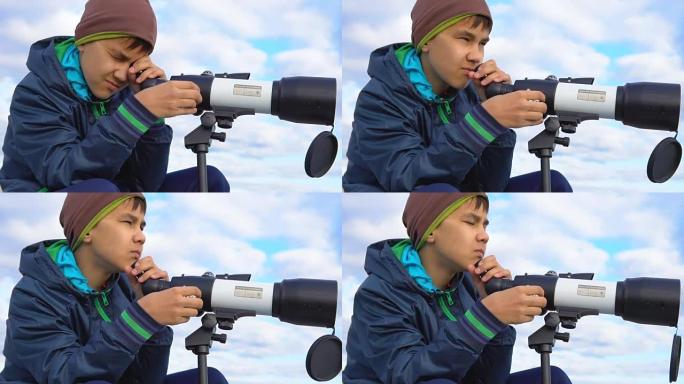 一个青少年通过望远镜看。