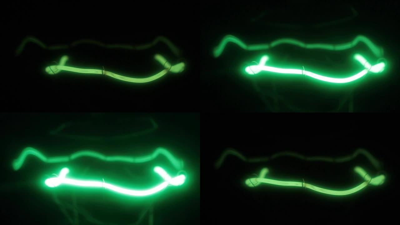 灯丝灯绿色螺旋的特写。平滑闪烁