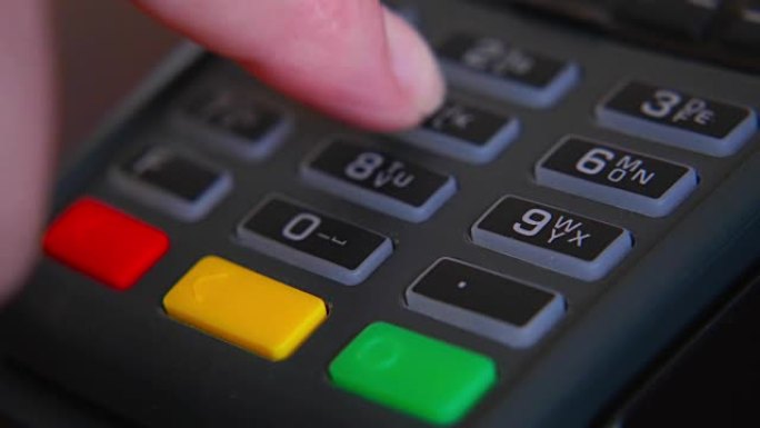 Female hand with a bank card using the terminal fo