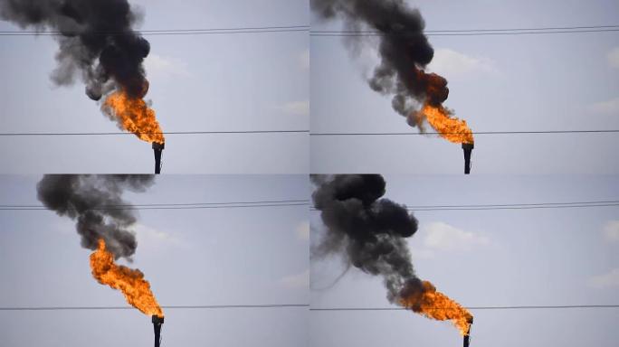 吸烟的气体火炬。环境污染。油田上的火炬系统