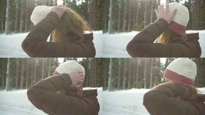 一个美丽的年轻女子在下雪天戴上无檐小便帽的侧写照片