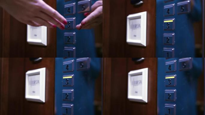 女性手将面板上的三楼按钮推入电梯轿厢