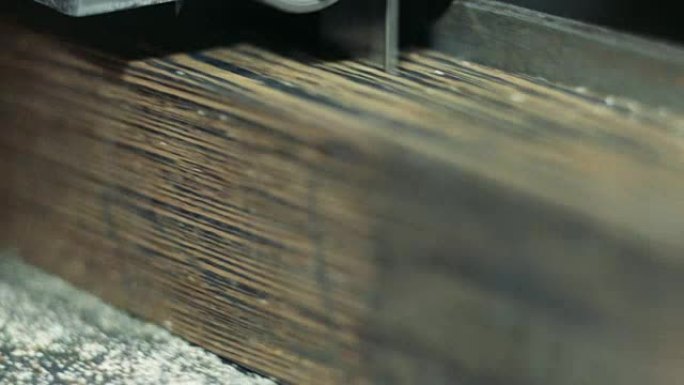 Luthier forms a billiard cue running on a band saw