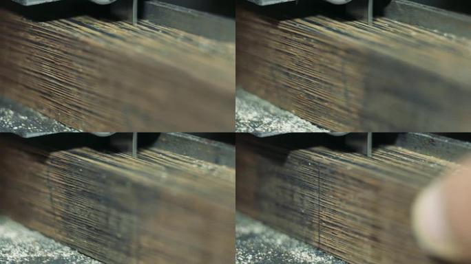Luthier forms a billiard cue running on a band saw