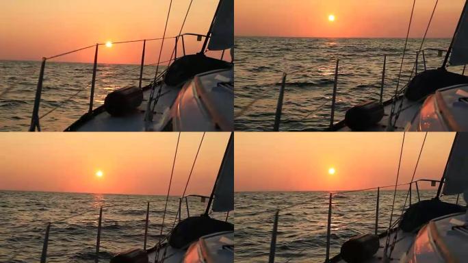 从帆船甲板上看，索具和预见轮廓映衬着灿烂的日落或日出的天空
