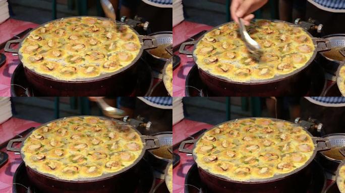 泰国曼谷的街头美食，是热锅炸牡蛎。