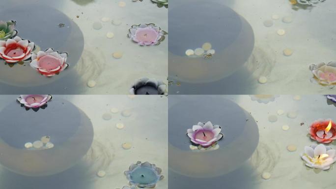 美丽的蜡色蜡烛形式的莲花燃烧和灭绝漂浮在水面上，特写镜头