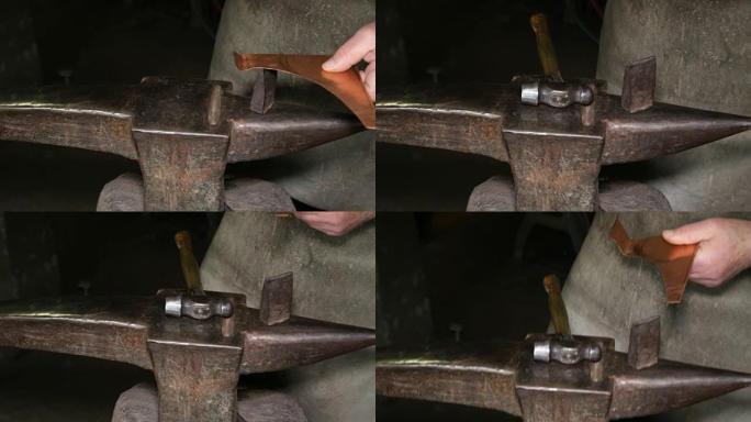 铜匠的车间: 用锤子敲打铁砧上的铜板