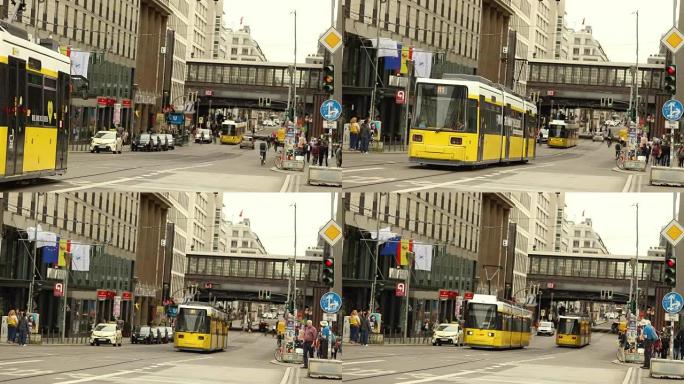 人们在sferophora上等待，黄色电车在灯火上等待，人们在等待黄色电车通过。德国柏林
