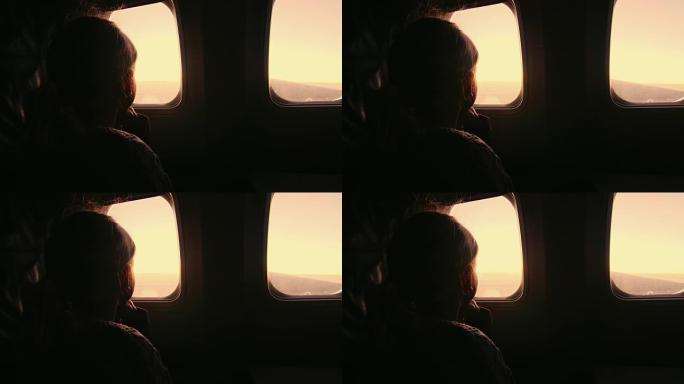 女孩坐在飞机上，看着窗外升起的太阳