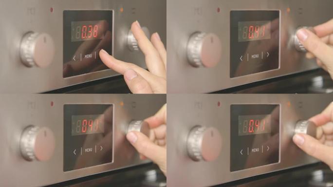 女人在厨房用电烤箱烘烤设置烘烤模式和温度