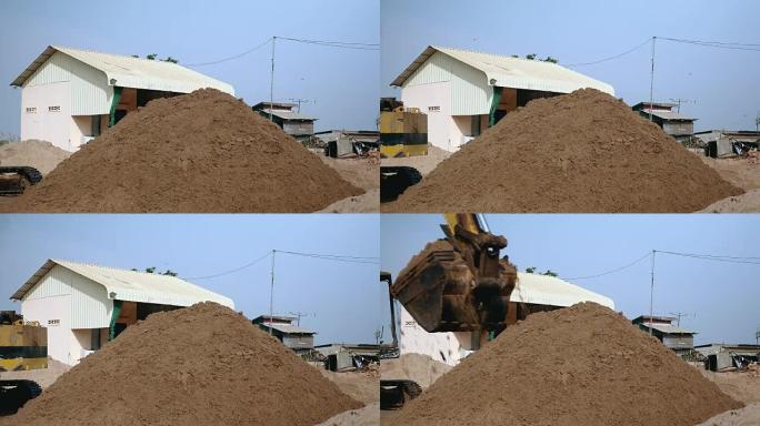 挖掘机在处置现场排放和堆沙 (特写)