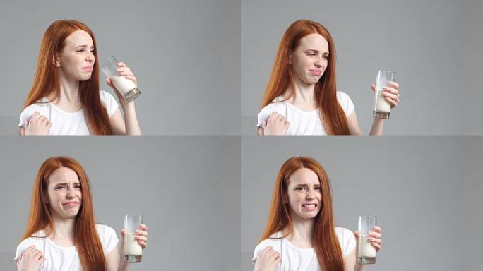 红发女孩正在喝杯子里的牛奶，不像牛奶