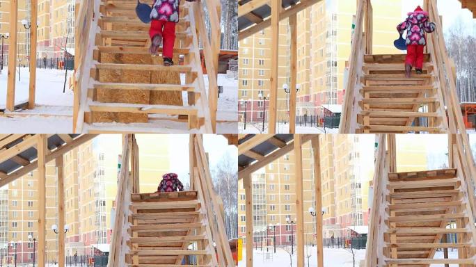 Child is climbing up slide stairs at playground