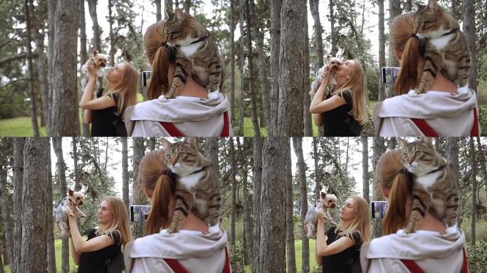 自拍照。一个背着猫的女孩带着一个女孩和一条狗