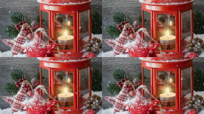 Cinemagraph of snow falling with candle in red lan