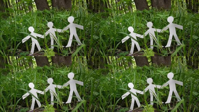 人和环境的概念。草上纸做的人形。静态摄像机视频高清