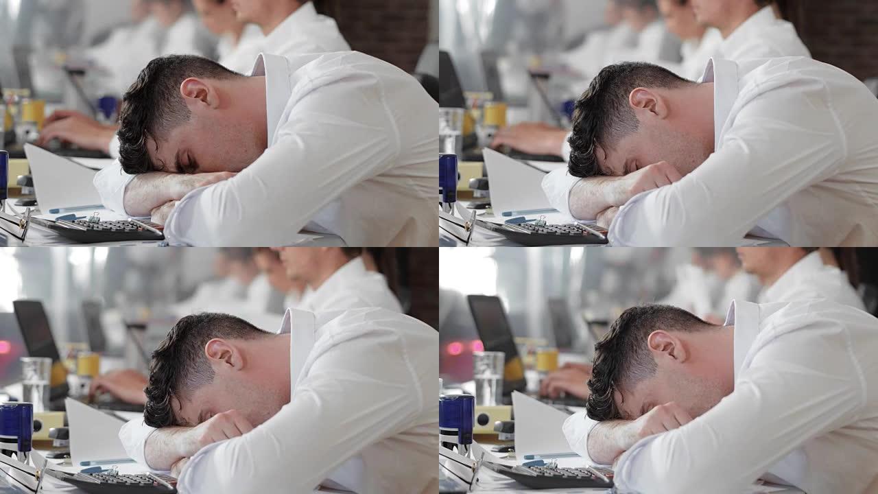 工作过度劳累的员工在工作中感到疲倦和睡觉