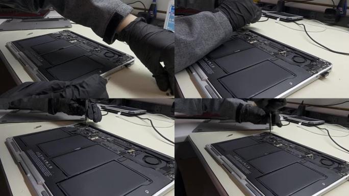 技术人员修理损坏的笔记本电脑