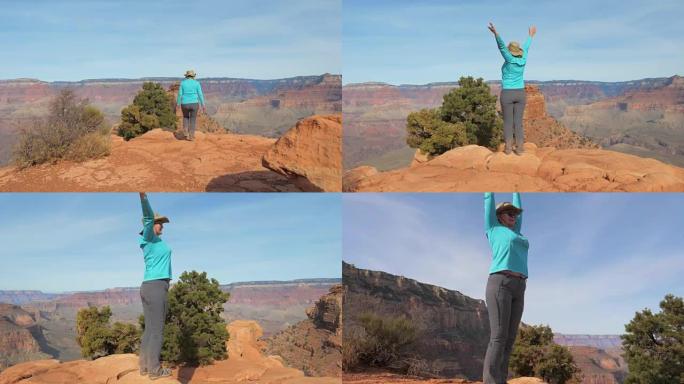 在大峡谷徒步旅行的女人正来到观察点，举起手臂
