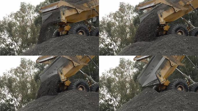卡车卸下刚刚在沙子和石头采石场中提取的河沙