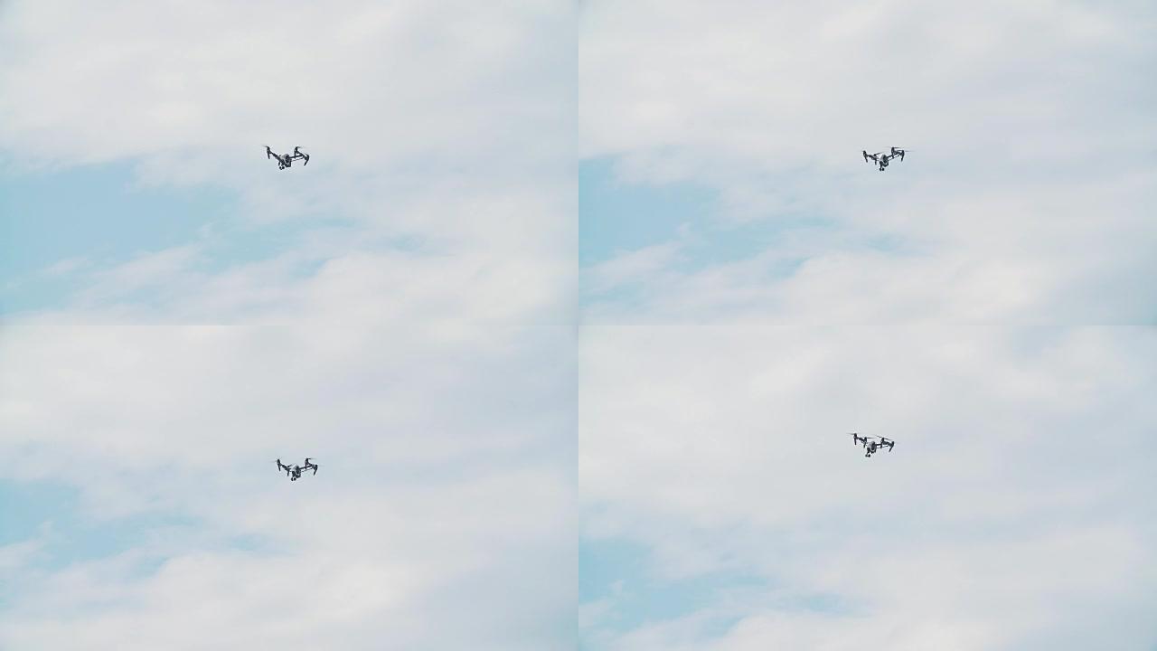 拍摄无人机在蓝天白云前飞行