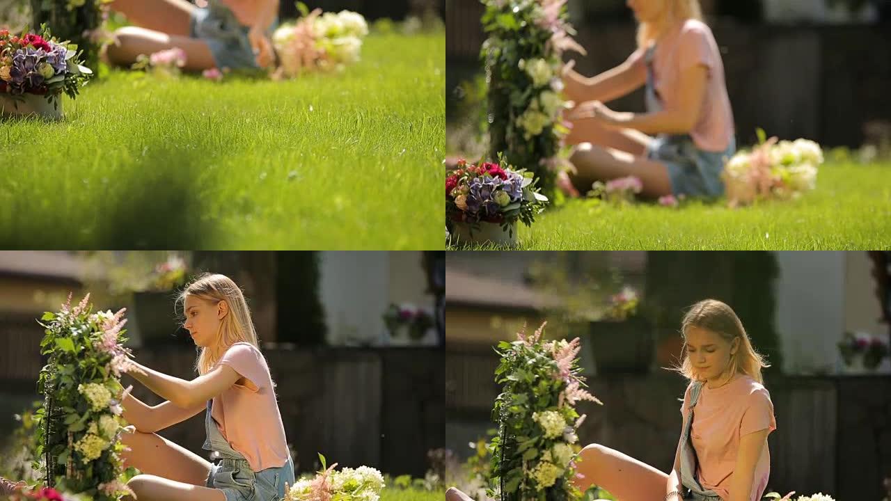 微笑的年轻欧洲金发女孩坐在翡翠草地上做一个花弧