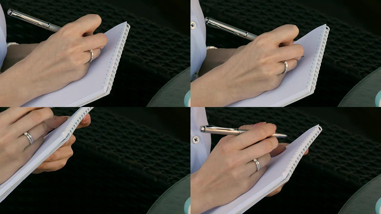 一个女孩在笔记本上写字的特写