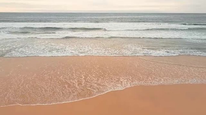 Drone flight over sea waves and sand beach