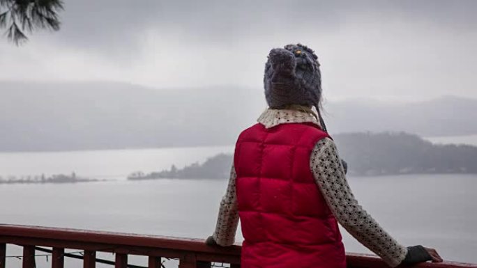 Woman with Fashionable red vest is Looking Out Ove